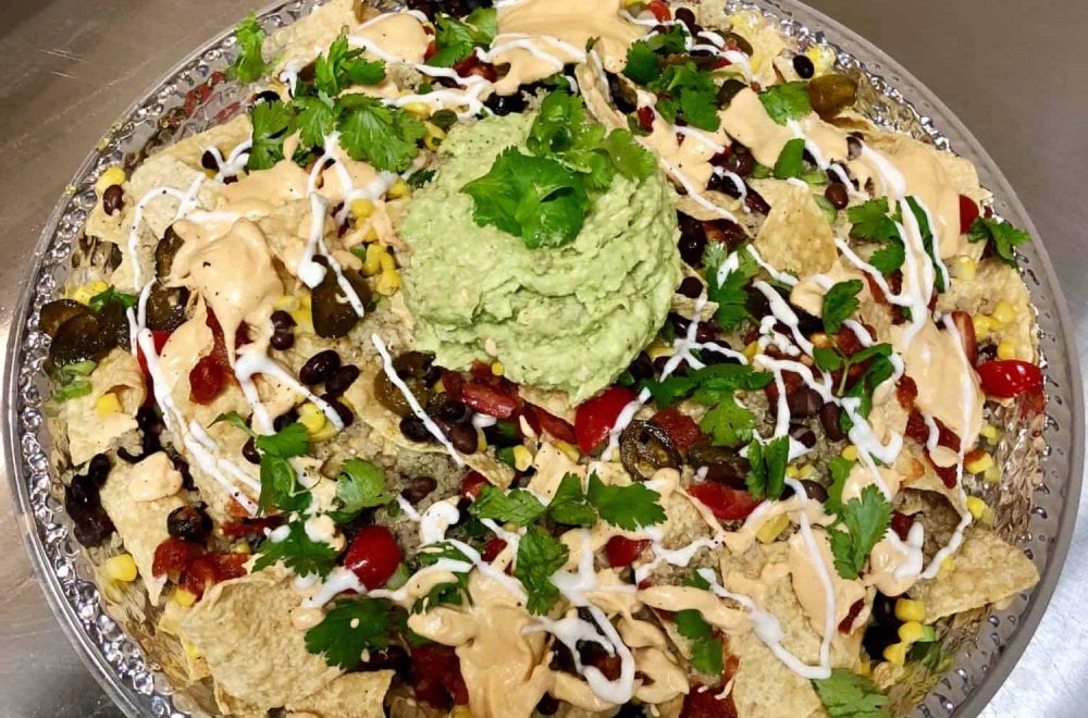 Plant-Based Nachos with Cashew Cheese Sauce, Guacamole and Cashew Sour Cream