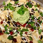 Plant-Based Nachos with Cashew Cheese Sauce, Guacamole and Cashew Sour Cream