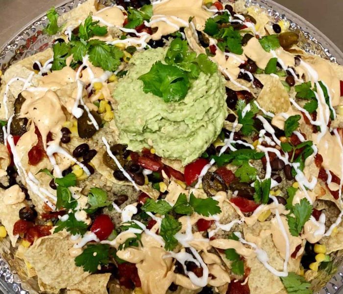 Plant-Based Nachos with Cashew Cheese Sauce, Guacamole and Cashew Sour Cream